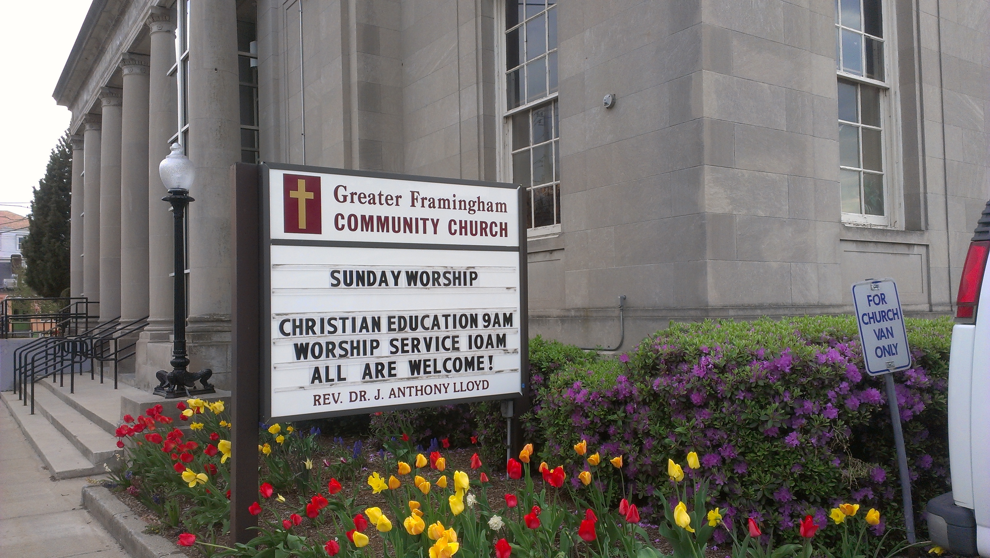 Church billboard outside the building: Welcome! Sunday service at 10am. Sunday School at 9am.