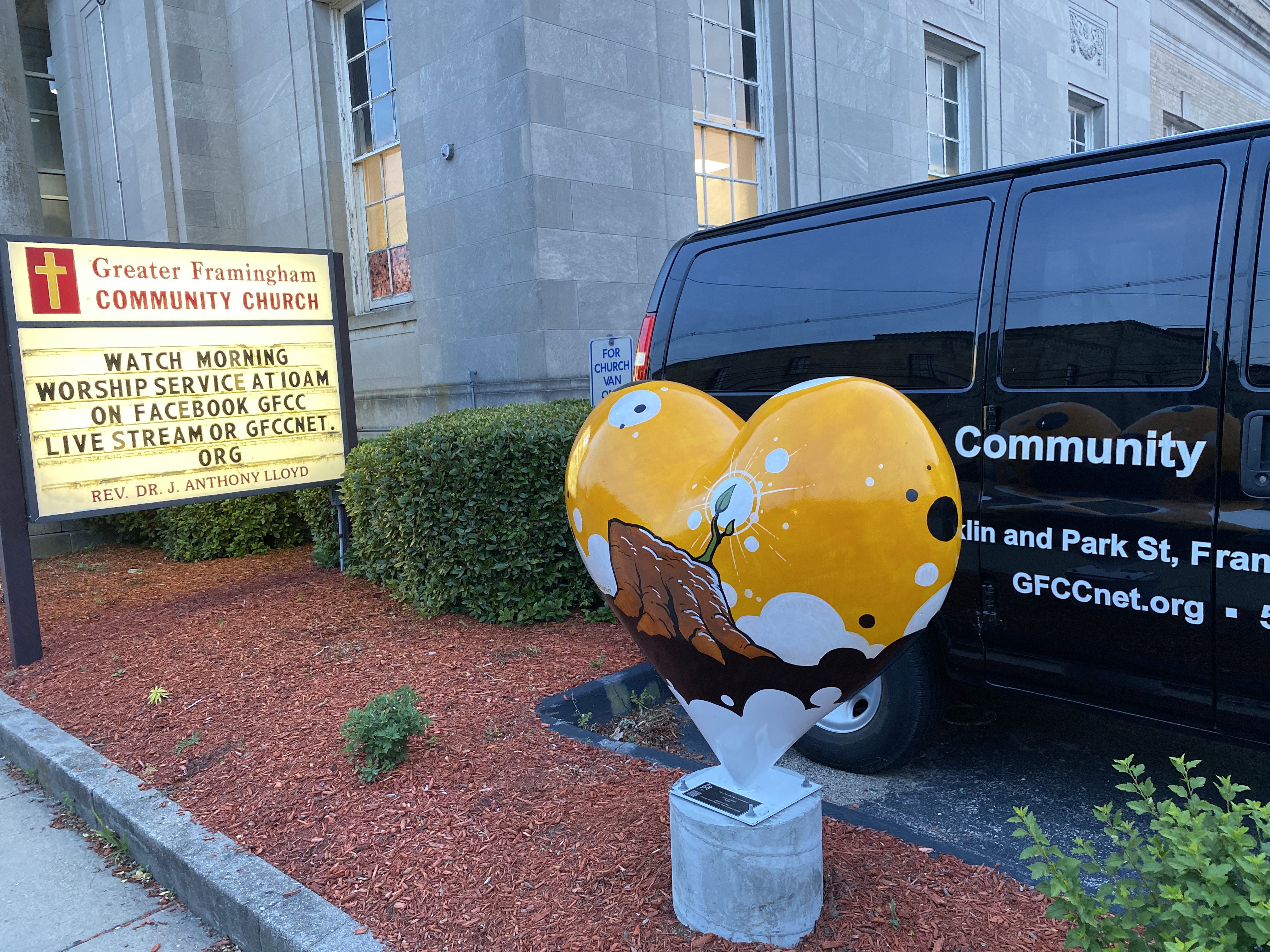 Hearts Around Framingham sculpture in front of the church van