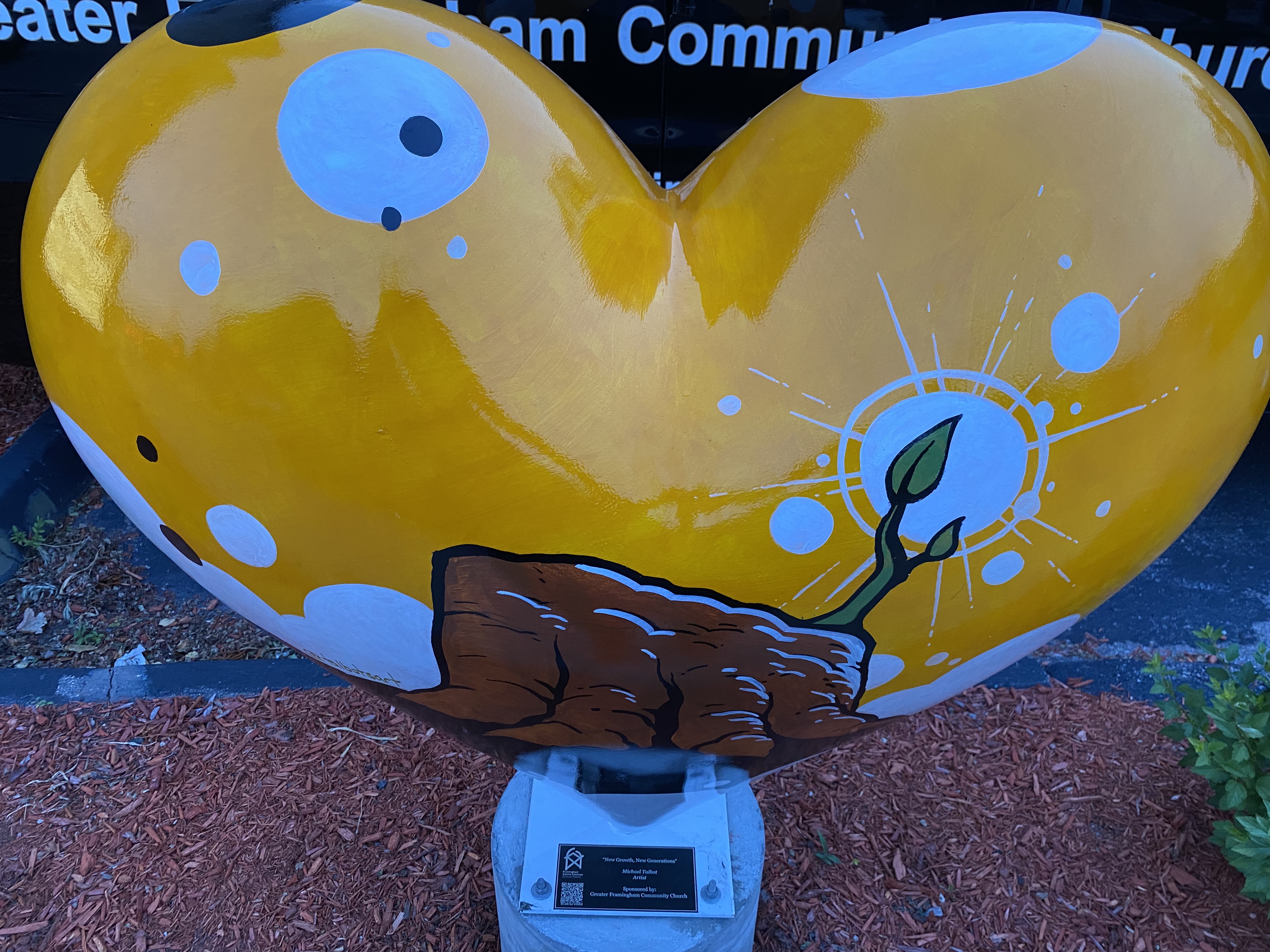 Hearts Around Framingham sculpture in front of the church van